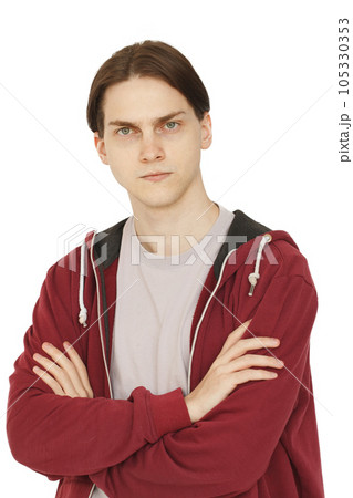 Serious puzzled young man with crossed arms portrait. Doubt, choice and think concept 105330353