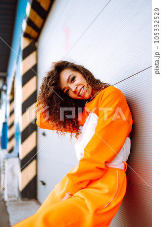 African American woman - dancer in the street at sunset. Sport, dancing and urban culture concept. Fashion lifestyle. African American woman - dancer in the street at sunset. Sport, dancing and urban culture concept. Fashion lifestyle. 105332529