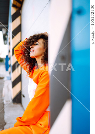 African American woman - dancer in the street at sunset. Sport, dancing and urban culture concept. Fashion lifestyle. African American woman - dancer in the street at sunset. Sport, dancing and urban culture concept. Fashion lifestyle. 105332530