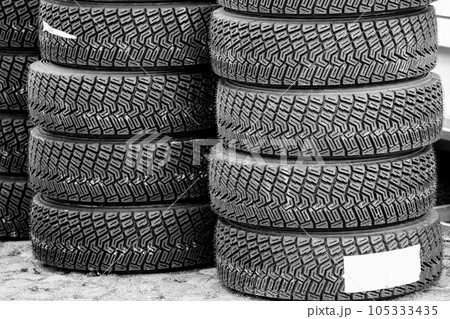 Sets of new high performance gravel rally tires, closeup of modern asymmetric tread pattern 105333435