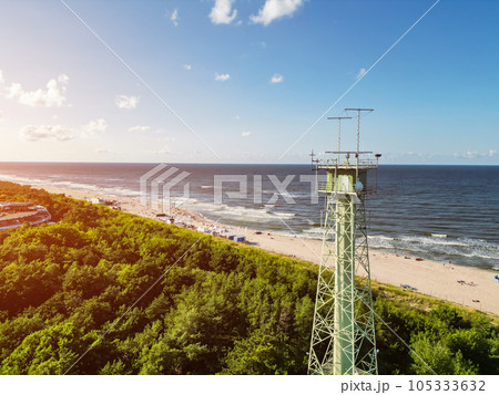 border observation tower with radar and antenna at sea shoe with beach 105333632