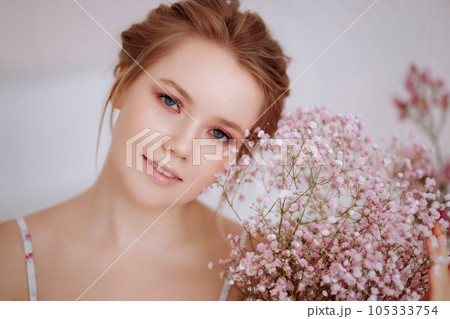 Close-up of a woman's face with flowers 105333754