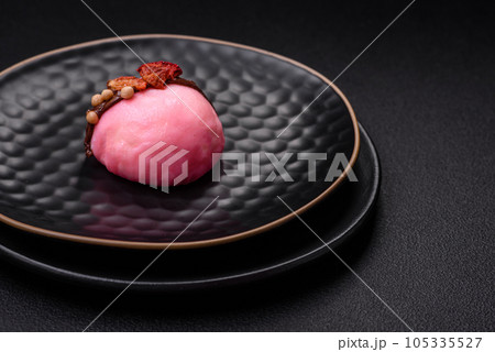 Delicious sweet colorful mochi desserts or ice cream with rice dough and toppings Delicious sweet colorful mochi desserts or ice cream with rice dough and toppings 105335527
