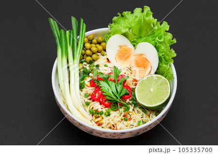 Noodle Dish with Green Onions, Eggs, Green Pea, Red Hot Pepper, Greens and Lime Noodle Dish with Green Onions, Eggs, Green Pea, Red Hot Pepper, Greens and Lime 105335700