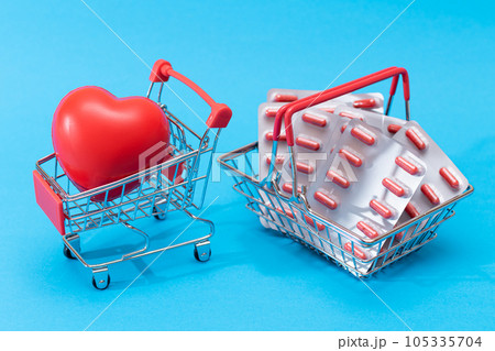 Pills and Capsules in Shopping Basket on Blue Background Pills and Capsules in Shopping Basket on Blue Background 105335704
