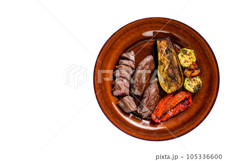 Grilled mutton tenderloin Fillet Meat, lamb sirloin on rustic plate with vegetables. High quality Isolate, white background. 105336600