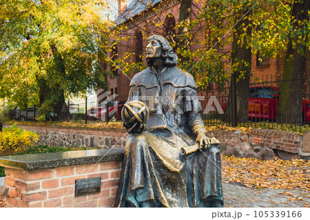 Olsztyn Poland - October 2022 Planet in hand of Nicolaus Copernicus statue near his famous castle. Nicolaus Copernicus statue on the Old Town in Olsztyn. Famous tourist attraction travel Olsztyn Poland - October 2022 Planet in hand of Nicolaus Copernicus statue near his famous castle. Nicolaus Copernicus statue on the Old Town in Olsztyn. Famous tourist attraction travel 105339166