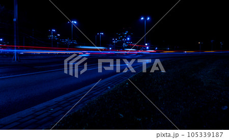 Lights of cars at night. Street line lights. Night highway city. Long exposure photograph night road. Colored bands of red light trails on the road. Background wallpaper defocused  105339187
