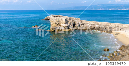 View of coastline in southern Italy. Scenic view from on top cliff looking out to sea. Calabria coastline with eroded cliff View of coastline in southern Italy. Scenic view from on top cliff looking out to sea. Calabria coastline with eroded cliff 105339470