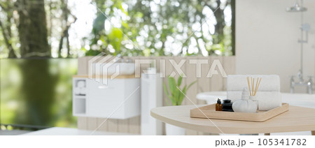 Spa accessories on the wooden table with modern bathroom background. Spa accessories on the wooden table with modern bathroom background. 105341782