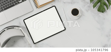 Top view of minimal workspace with blank screen mock up tablet, coffee cup, vr glasses. 105341796