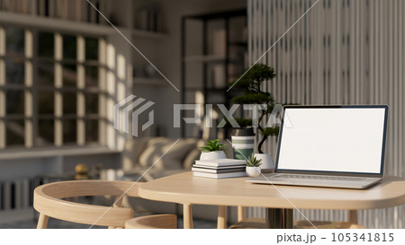 A laptop mockup, potted plants, and decor on a wooden table in a minimal living room. 105341815