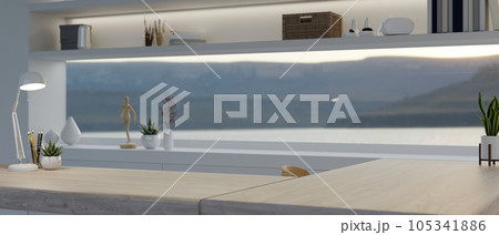 Copy space on a wooden tabletop in a modern home office with a long window and decor. 105341886