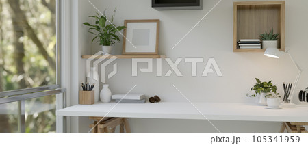 A minimal white tabletop with copy space against the white wall near the window. A minimal white tabletop with copy space against the white wall near the window. 105341959