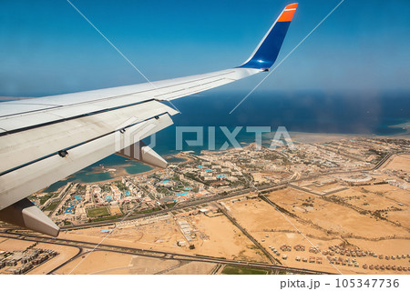 Aerial View of the Red Sea Coast in Hurghada, Egypt with many hotels bay out of airplane landing 105347736