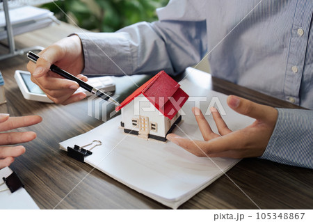 Real Estate Agent and client talking about Property insurance and security concept about house to client before sign contract. Real Estate Agent and client talking about Property insurance and security concept about house to client before sign contract. 105348867