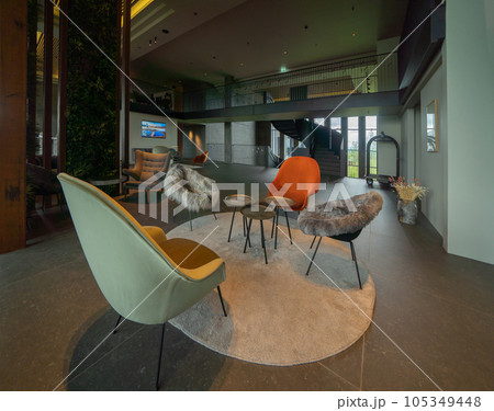 Inside of modern hotel lobby lounge with bookshelves library, entrance, and reception, waiting area, indoor. Inside of modern hotel lobby lounge with bookshelves library, entrance, and reception, waiting area, indoor. 105349448