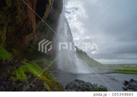 Seljalandsfoss waterfall in summer season in Iceland. Famous nature landscape background Seljalandsfoss waterfall in summer season in Iceland. Famous nature landscape background 105349665