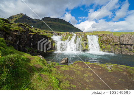 Kirkjufell mountain and river in Iceland in summer season. Famous landscape nature background at sunset 105349699
