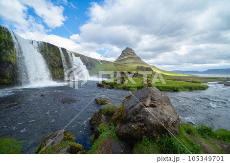 Kirkjufell mountain and river in Iceland in summer season. Famous landscape nature background at sunset 105349701