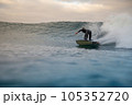 surfer riding waves on the island of fuerteventura 105352720