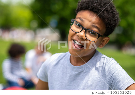 Smiling curly-haired african american teen looking happy Smiling curly-haired african american teen looking happy 105353029