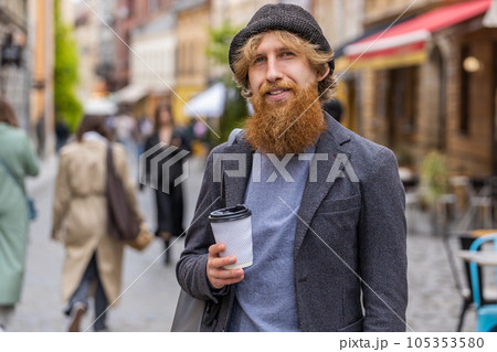 Young man enjoying drinking morning coffee hot drink, relaxing, taking a break in city street Young man enjoying drinking morning coffee hot drink, relaxing, taking a break in city street 105353580