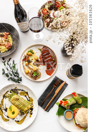 View from above of several plates of food. Variety of different dishes.  105361626