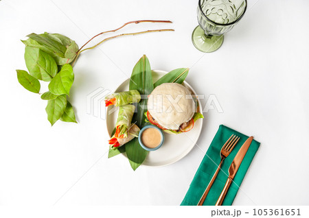 Burger with Bao steamed buns, spring rolls and sesame sauce 105361651