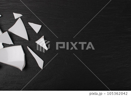 Broken Plate, White Ceramic Pieces, Smashed Bowl, Stress Concept, Porcelain Shards on Black 105362042