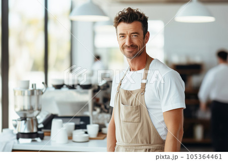 Portrait of a male barista barista wearing apron working at the counter in cafe indoors 105364461