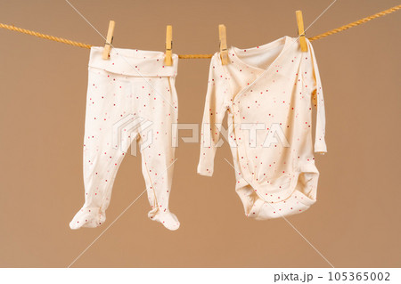 Kid's apparel pinned to a clothesline to dry 105365002