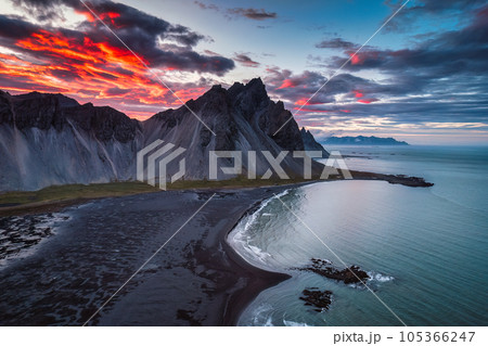 Dramatic sunset sky over Vestrahorn mountain and black sand beach in Stokksnes peninsula at Iceland 105366247
