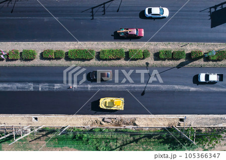 New asphalt road and road roller working in improvement project New asphalt road and road roller working in improvement project 105366347
