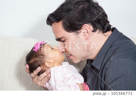 Portrait of young father at home with his one month baby girl. Fatherhood concept. Family love concept. 105366772