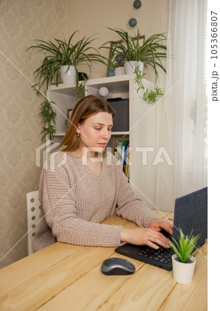 Pretty schoolgirl studying homework math during her online lesson 105366807