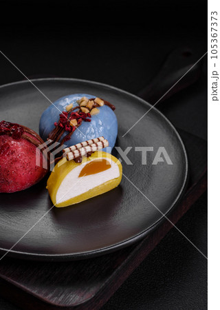 Delicious sweet colorful mochi desserts or ice cream with rice dough and toppings Delicious sweet colorful mochi desserts or ice cream with rice dough and toppings 105367373