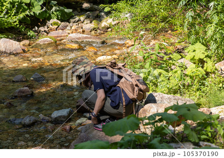 清流の冷たさを実感する女性ハイカー 清流の冷たさを実感する女性ハイカー 105370190