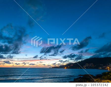 The sky changes color from yellow to red as the sun sets over the sea..sunset landscape amazing light of nature cloudscape sky. .Big sun and red lighting sky background. 4k resolution 105372142