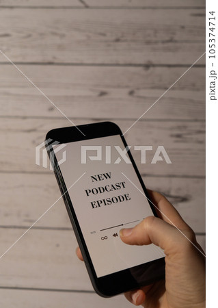 Unrecognizable woman holding mobile phone NEW PODCAST EPISODE listening website page app application with wireless headphones. Audio healing, sound therapy wellness rituals, positive mental health Unrecognizable woman holding mobile phone NEW PODCAST EPISODE listening website page app application with wireless headphones. Audio healing, sound therapy wellness rituals, positive mental health 105374714