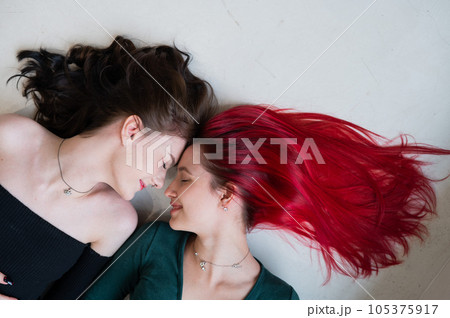 Top view of two women lying side by side. Lesbian intimacy. 105375917