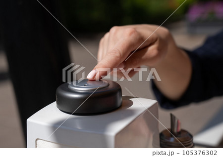 Woman pressing button to call waiter in cafe.  105376302
