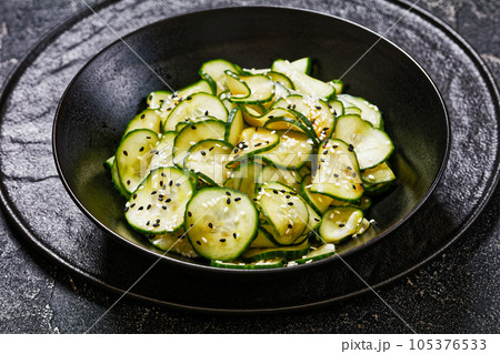 Sunomono, Japanese Cucumber Salad in a black bowl Sunomono, Japanese Cucumber Salad in a black bowl 105376533