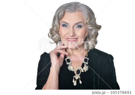 portrait of happy senior woman posing against white background 105376691