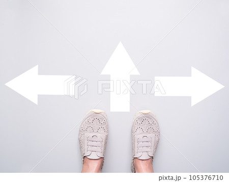 Foot Standing on White Wall with Sign Arrow Change Way,Alone Young Girl Go Walk Journey Step,Start Choice New Life,Strong woman,Business Finance Trade Stock Market Profit or Loss ,Broken Heart Concept 105376710