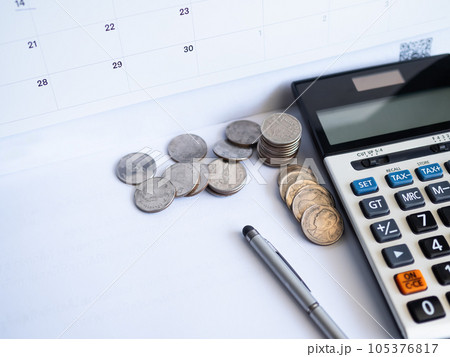 Calculator with Stack Coin,Pen,on Table Background,Free Space,Cash Money in Ofice,for Business Investment Income Finance Insurance Rate Number Bank,Accounting Currency Loan Credit Tax Concept. 105376817
