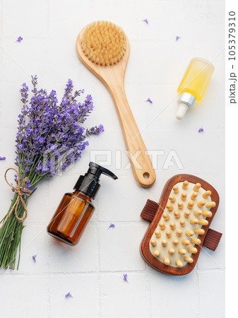 Lavender spa. Lavender salt, natural essential oil, massage brushes and fresh lavender 105379310