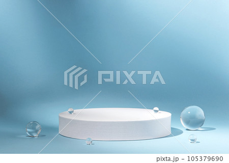 White podium with glass balls on a blue background for product presentation. Minimal concept and hard sunlight. White podium with glass balls on a blue background for product presentation. Minimal concept and hard sunlight. 105379690