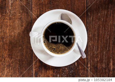 Coffee cup on dark wooden table Coffee cup on dark wooden table 105382184