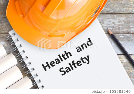 Health and safety with orange helmet,pencil and notebooks Health and safety with orange helmet,pencil and notebooks 105383340